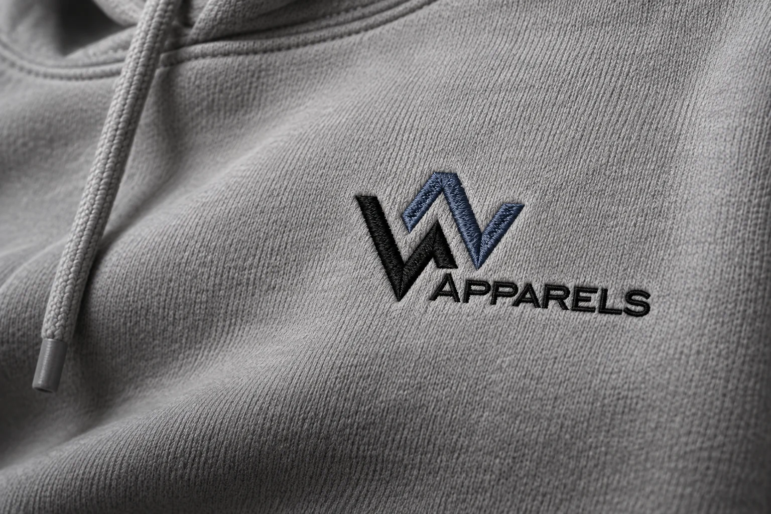 The supplied WhatsNext logo interpreted as embroidery on grey hoodie fabric — proposed finish