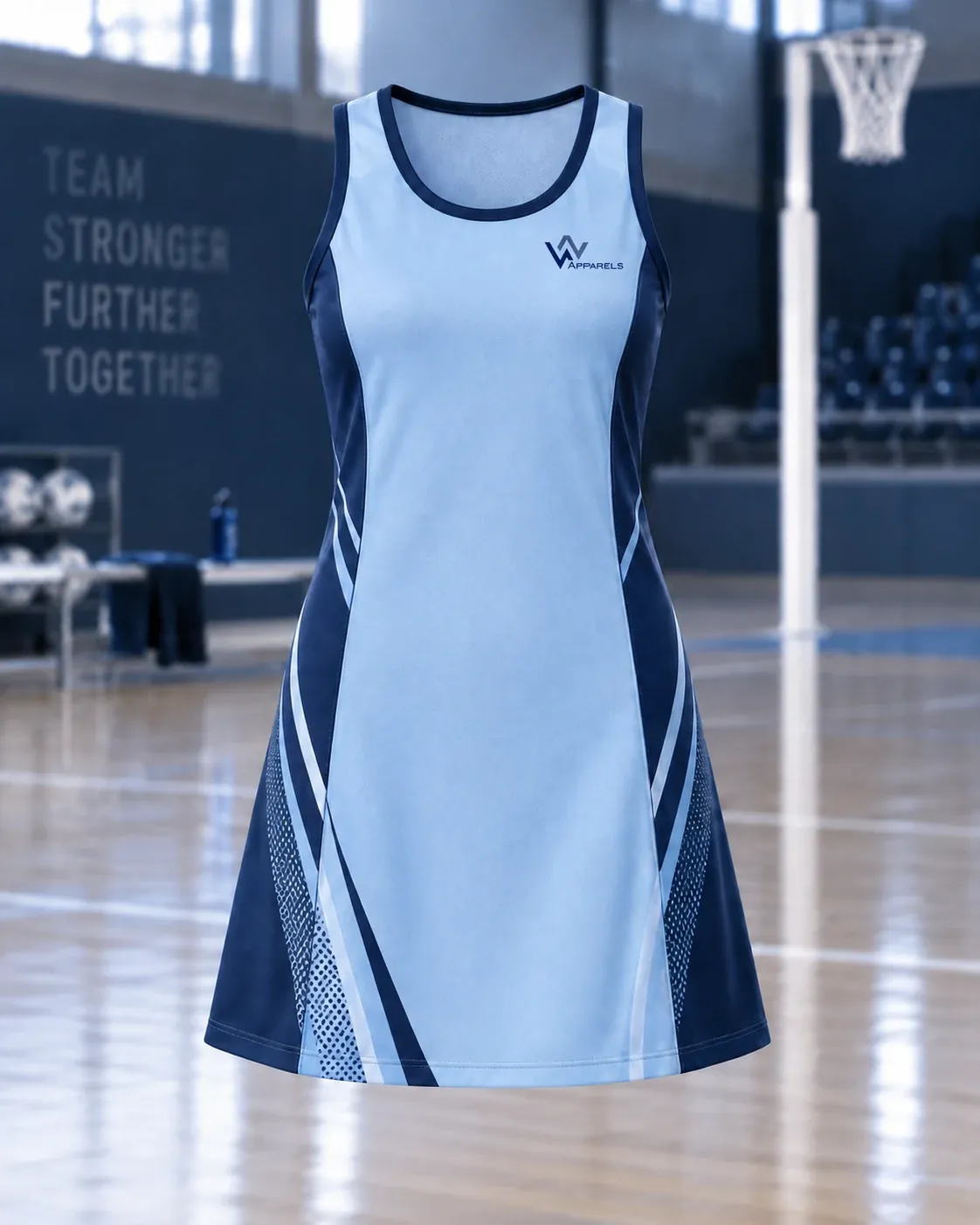 Sky-blue netball dress with navy side panels on an indoor court
