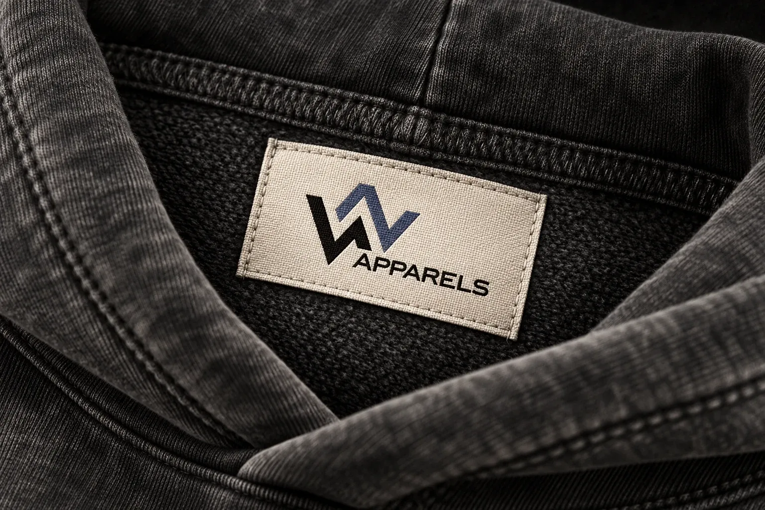 Close-up of a woven W Apparels neck label inside a washed hood
