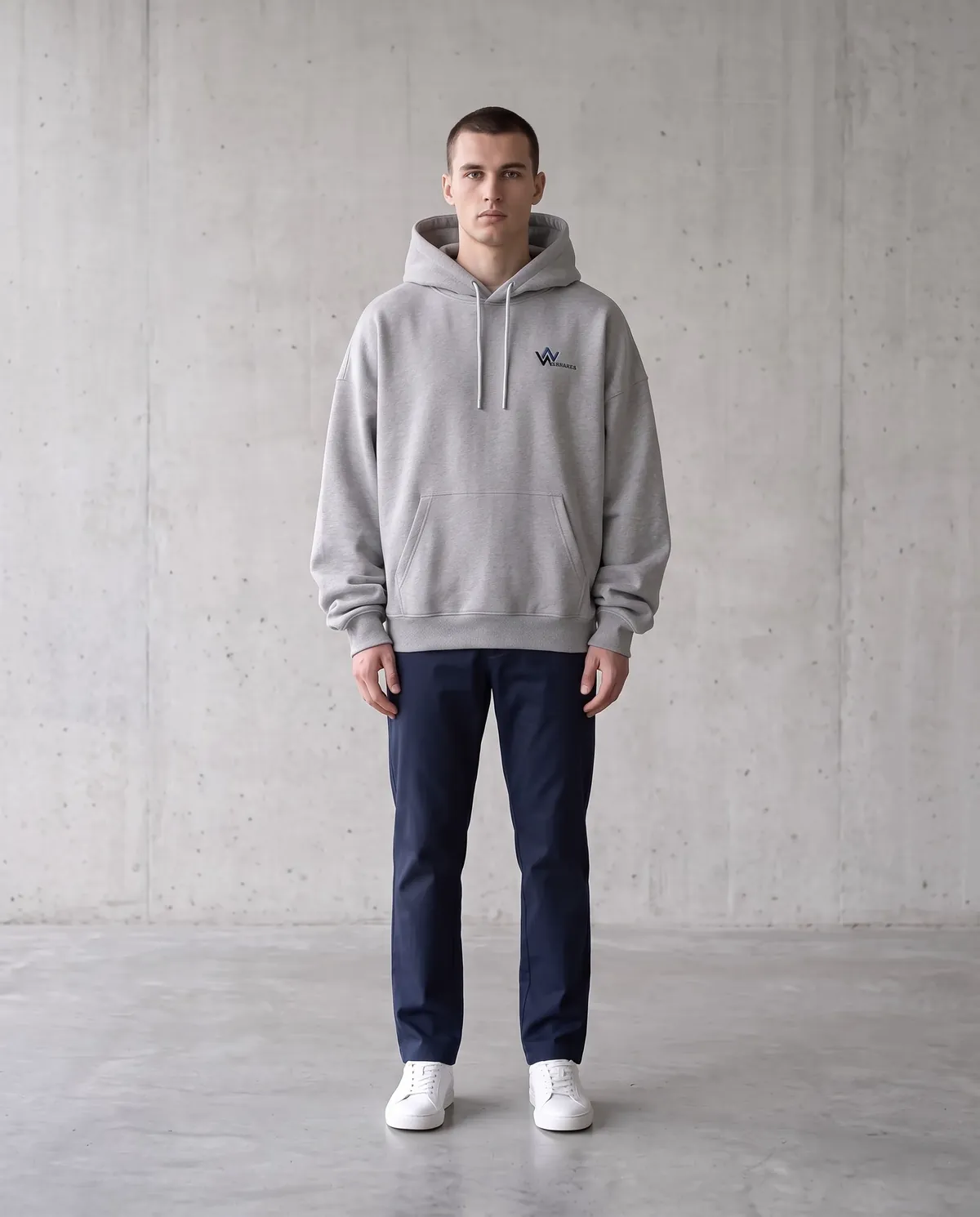 Model in an oversized heather-grey hoodie with dropped shoulders